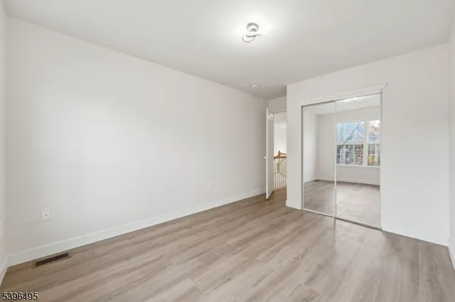 a bathroom with a granite countertop sink vanity mirror and toilet