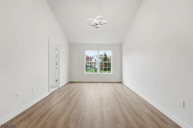 a view of a livingroom with wooden floor and a fireplace