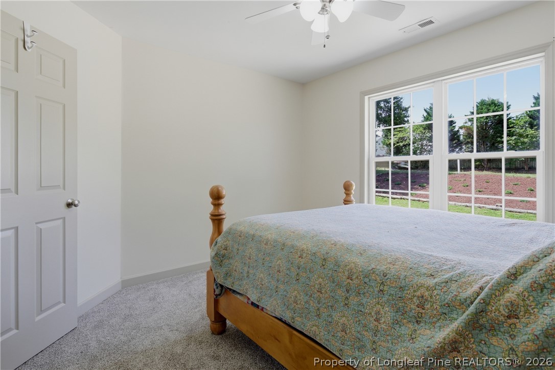 1075 Buffalo Lake Road Sanford, NC 27332 - Photo 33 of 49 a bedroom with a bed and a large window