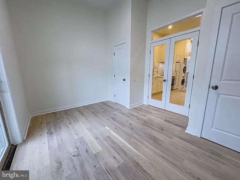 2011 Green Street, Unit 2R Philadelphia, PA 19130 - Photo 12 of 15 an empty room with wooden floor and a window