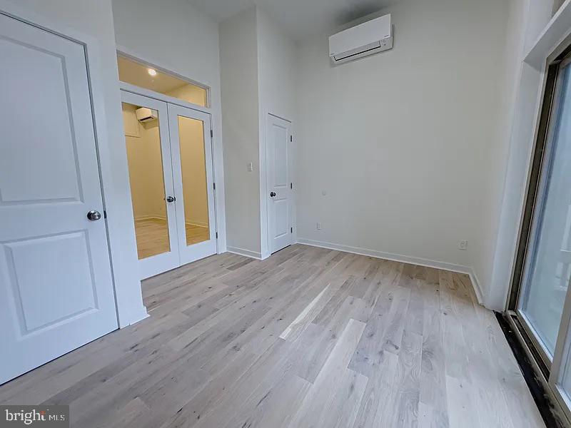 2011 Green Street, Unit 2R Philadelphia, PA 19130 - Photo 13 of 15 an empty room with wooden floor and a window