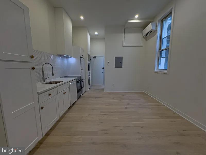 2011 Green Street, Unit 2R Philadelphia, PA 19130 - Photo 10 of 15 a open kitchen with kitchen island a sink stainless steel appliances and cabinets