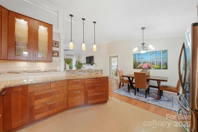 a kitchen with stainless steel appliances granite countertop a stove a sink and a wooden floors