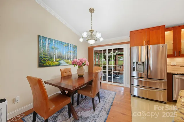 a dining room with furniture a chandelier and window