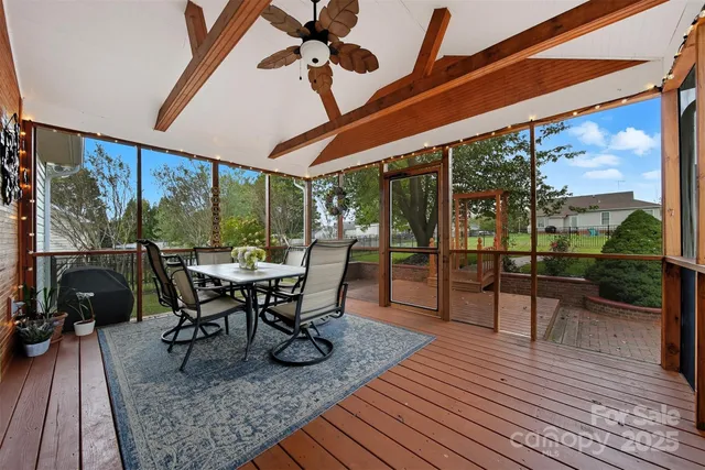 a view of a patio with table and chairs floor to ceiling window with wooden floor