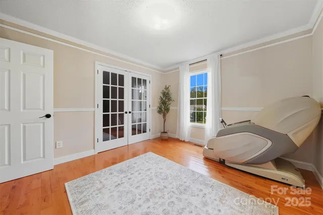 a view of a bedroom with furniture and window