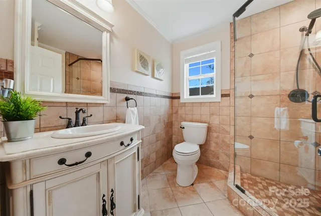 a bathroom with a sink toilet and shower