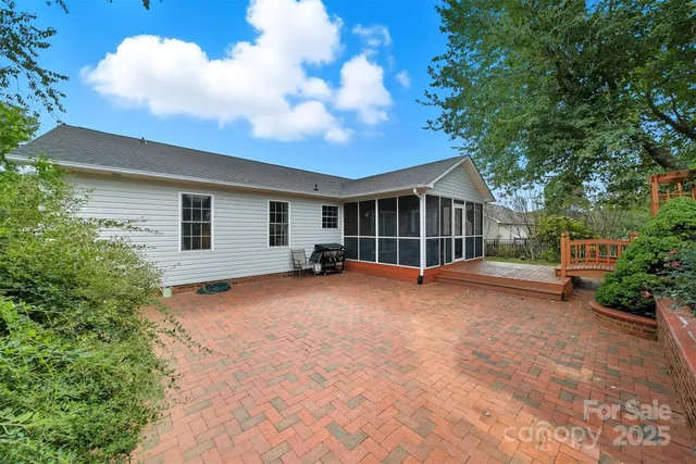 a view of a house with a yard and potted plants