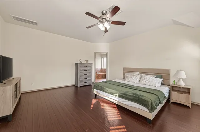 a bedroom with a bed furniture and a large window