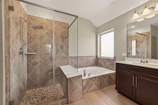 a bathroom with a tub sink and shower