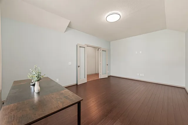 a view of an empty room and wooden floor