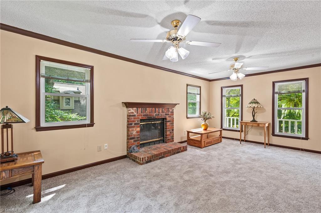 2605 Gordon Road High Point, NC 27265 - Photo 9 of 20 Living room with new carpeting and a wood burning fireplace