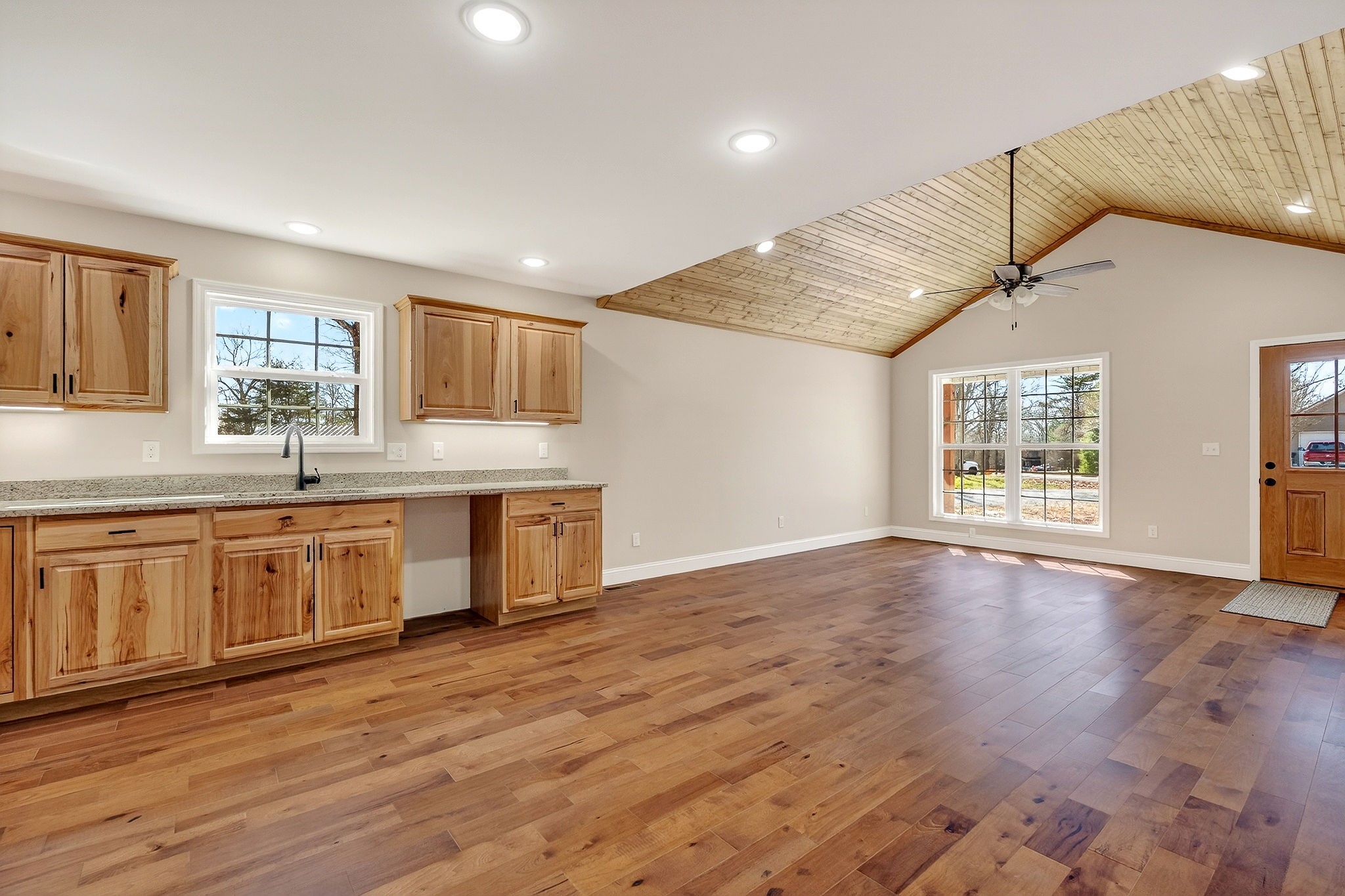 270 Rich Loop Sparta, TN 38583 - Photo 14 of 41 a open kitchen with granite countertop a stove a sink wooden floor cabinets and a dining table