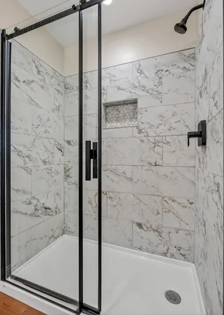 a bathroom with a shower and a bath tub