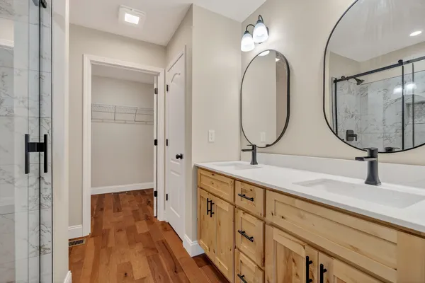 a bathroom with a double vanity sink and a mirror