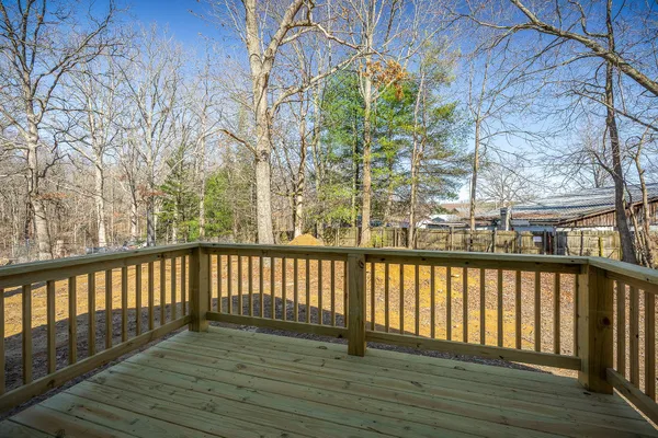 a view of balcony with wooden floor and fence