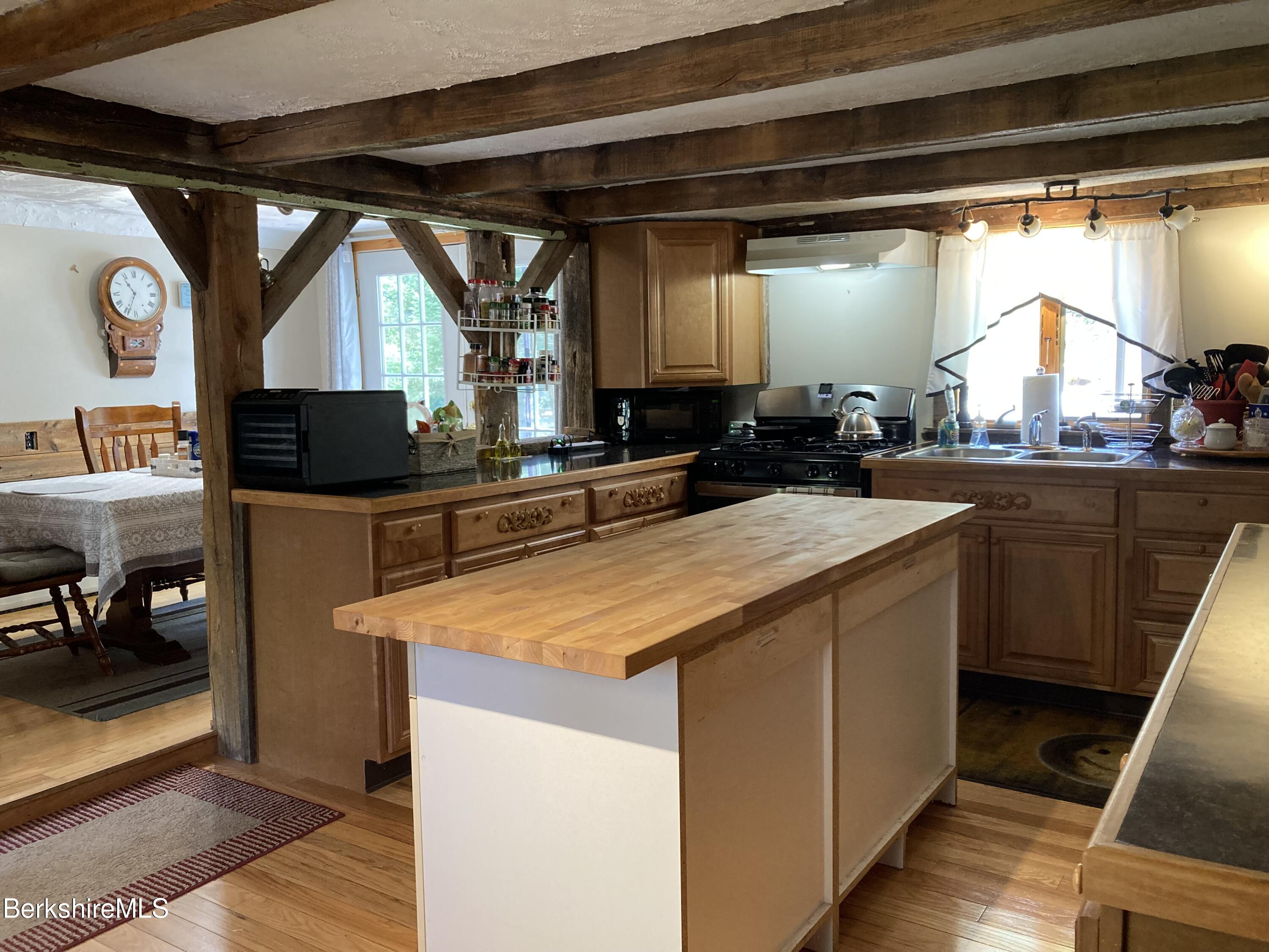 105 County Road Becket, MA 01223 - Photo 33 of 69 a kitchen with a sink a counter top space and a stove