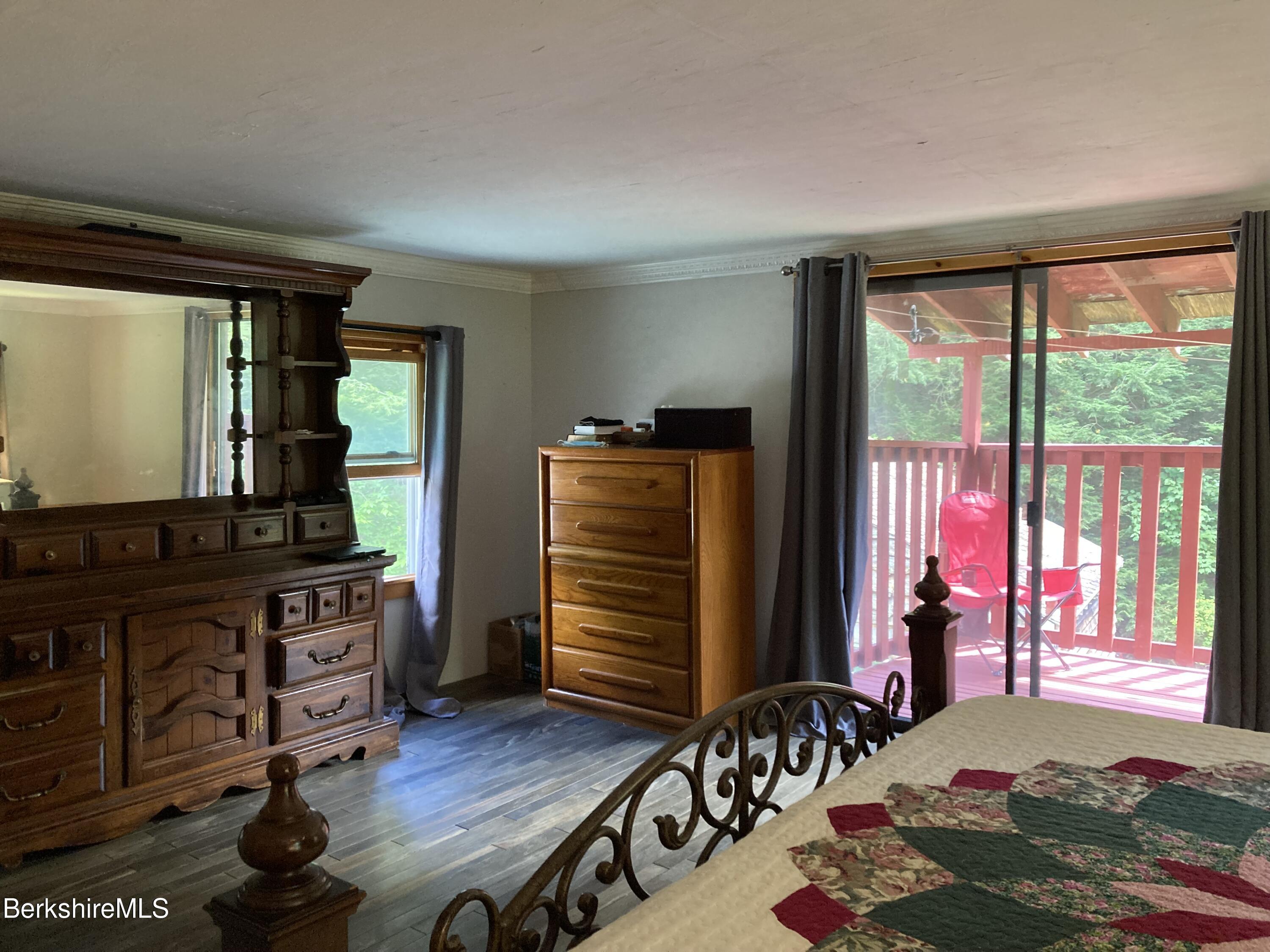 105 County Road Becket, MA 01223 - Photo 54 of 69 a bedroom with a bed and wooden floor