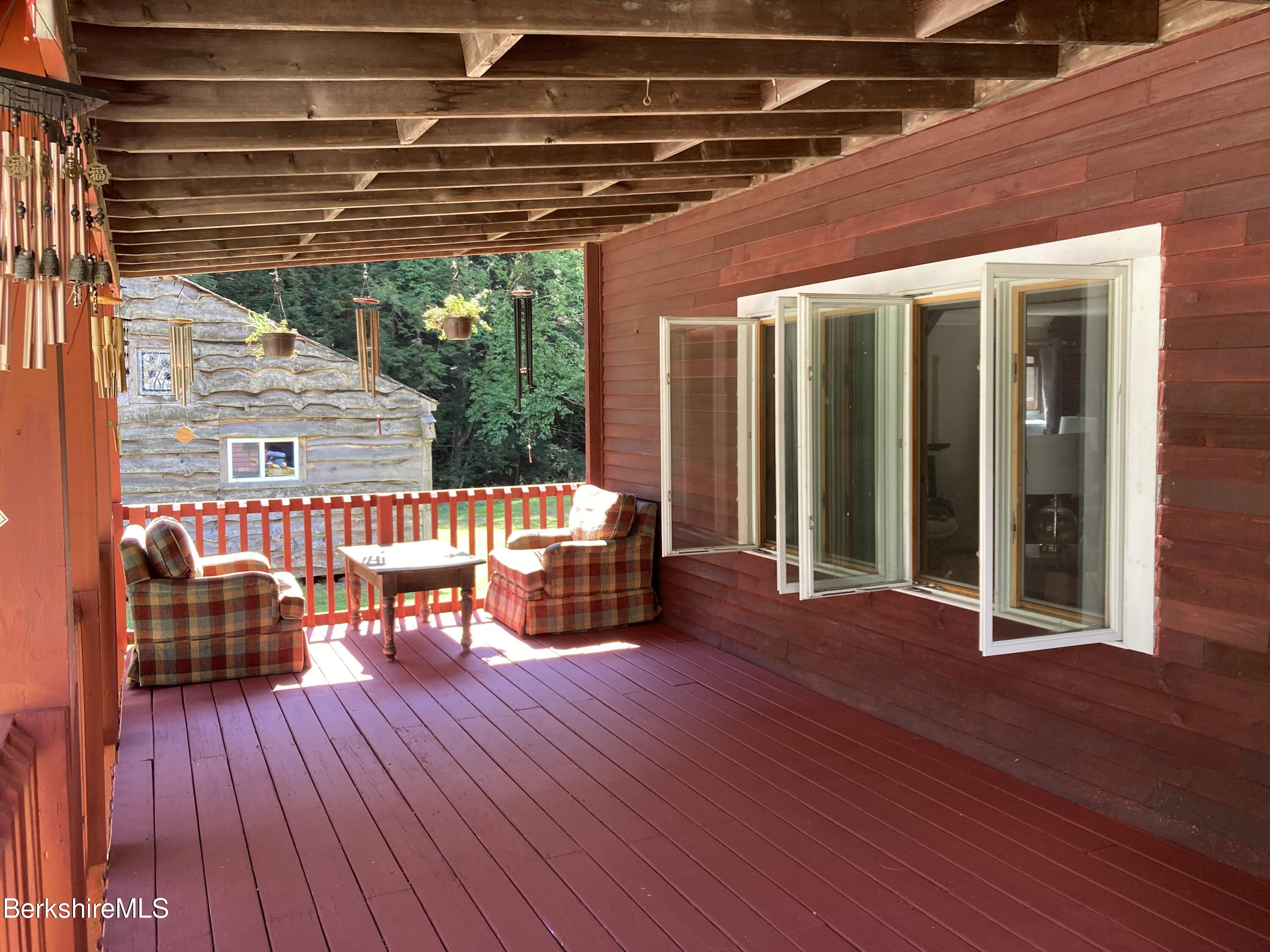 105 County Road Becket, MA 01223 - Photo 8 of 69 a patio with glass top table and chairs