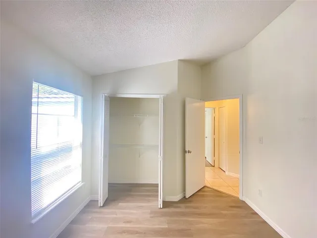 a view of a small space with wooden floor and a window