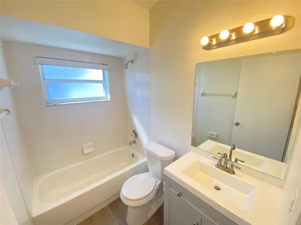 a bathroom with a sink mirror toilet and bathtub