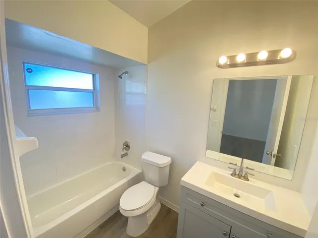 a bathroom with a sink mirror toilet and bathtub