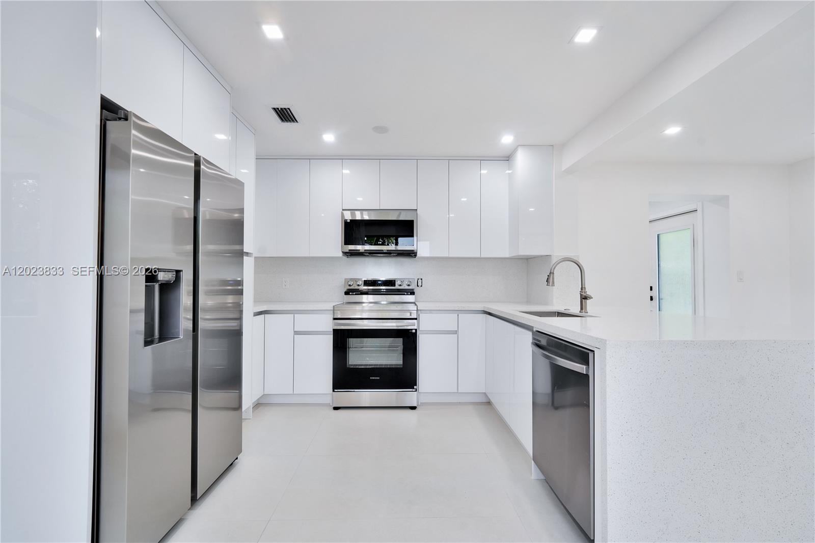 6566 Southwest 35th Street Miami, FL 33155 - Photo 8 of 36 a kitchen with white cabinets stainless steel appliances and sink