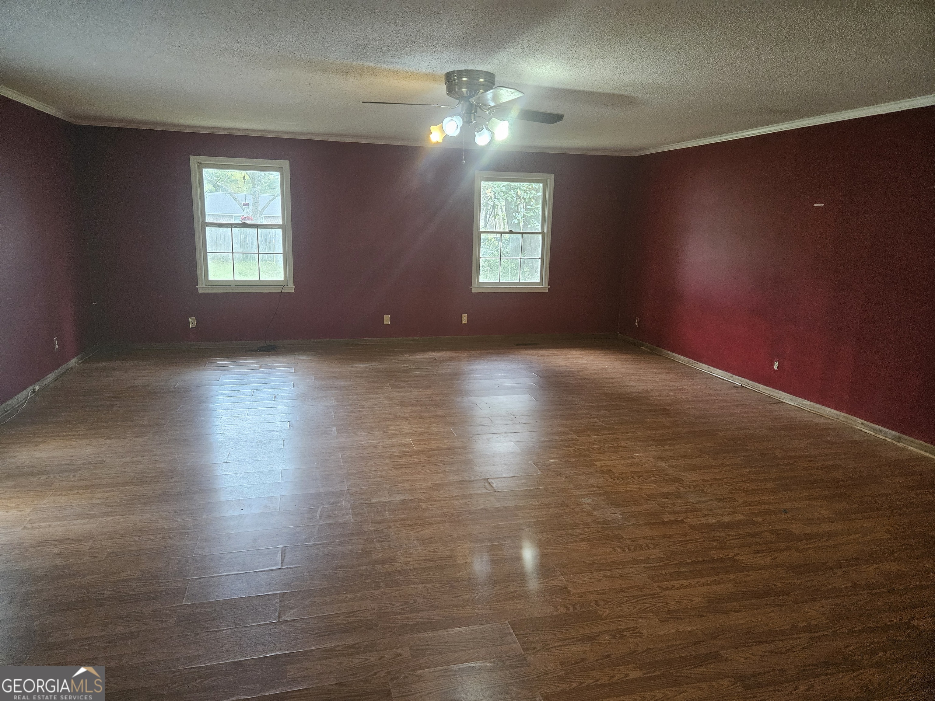 846 Harvey Street Millen, GA 30442 - Photo 14 of 34 an empty room with wooden floor and windows