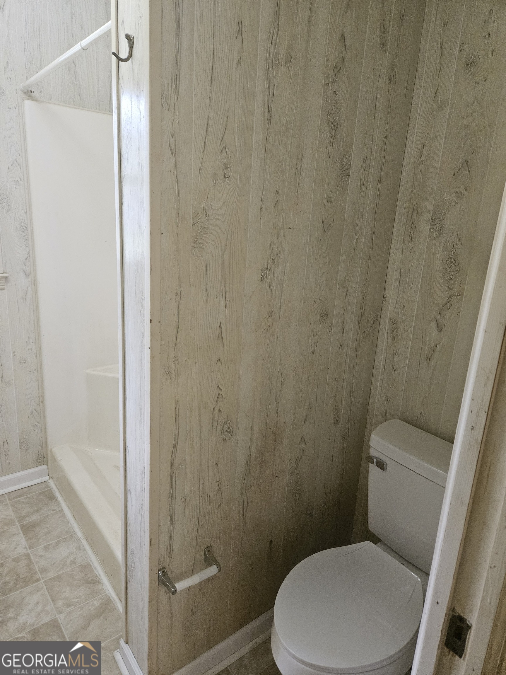846 Harvey Street Millen, GA 30442 - Photo 15 of 34 a white toilet sitting next to a shower curtain