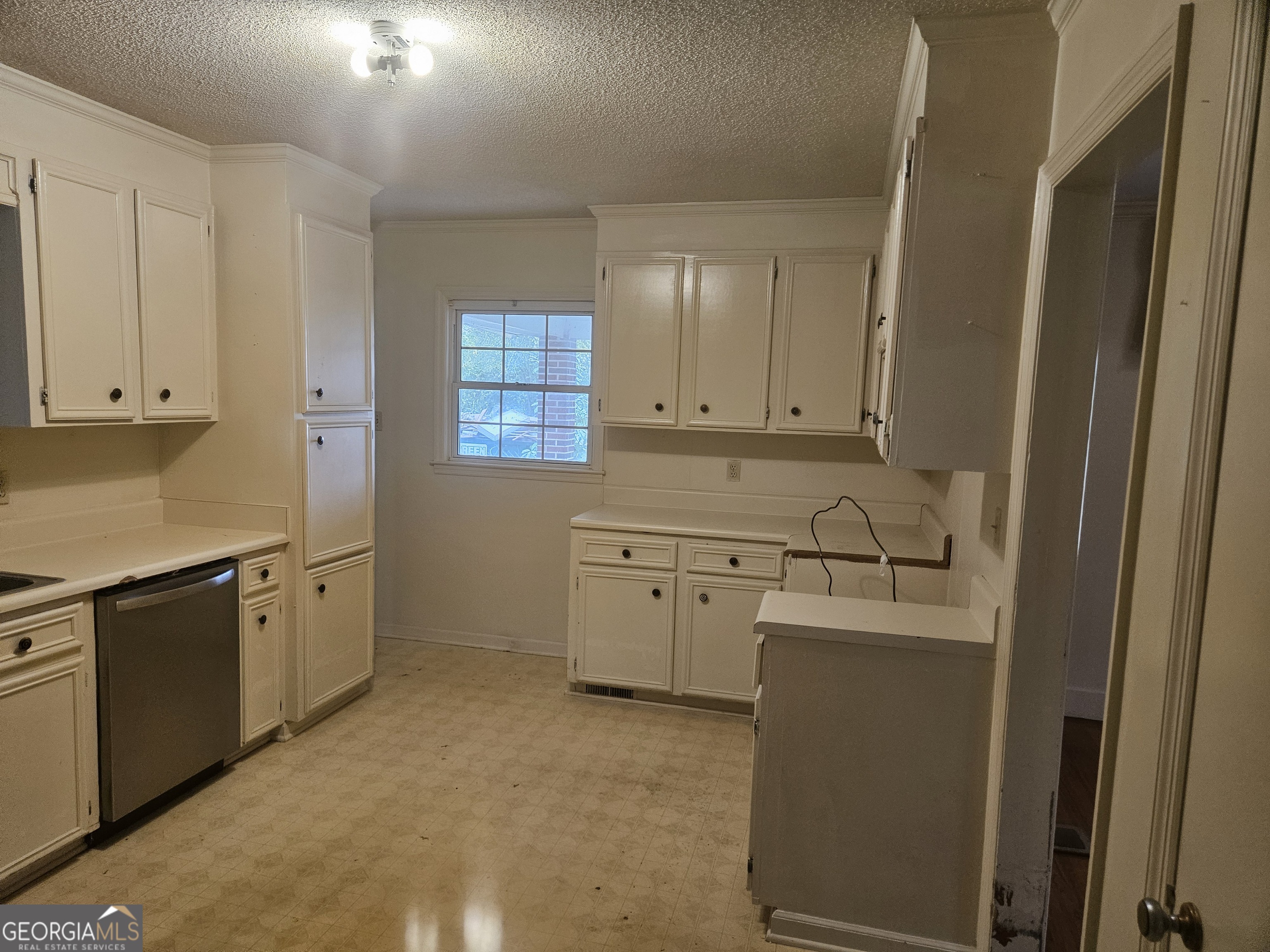 846 Harvey Street Millen, GA 30442 - Photo 18 of 34 a kitchen with cabinets appliances a sink and a window