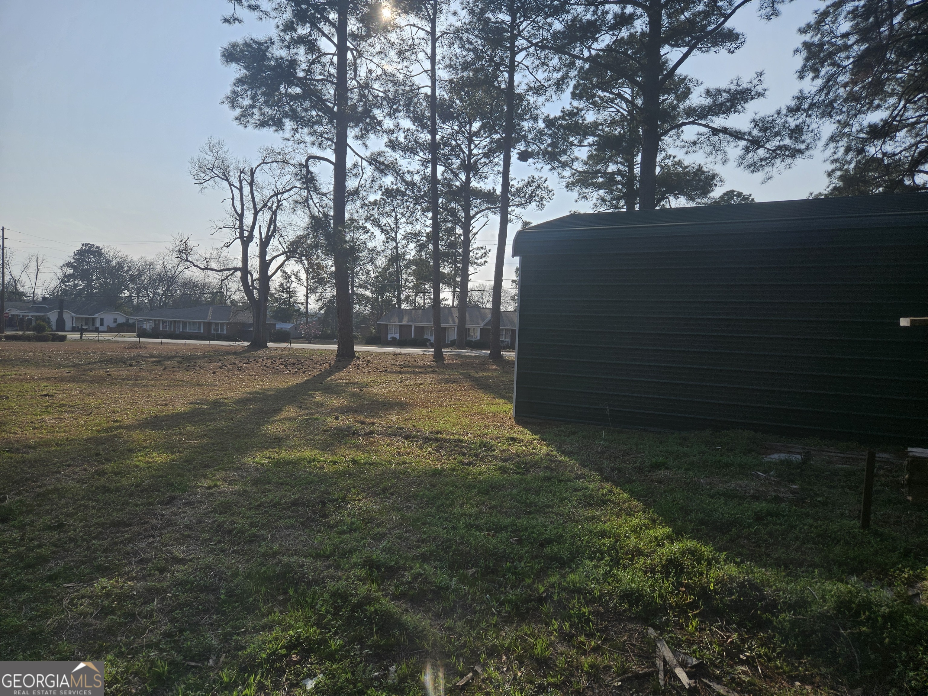 846 Harvey Street Millen, GA 30442 - Photo 22 of 34 a backyard of a house with lots of green space and outdoor seating
