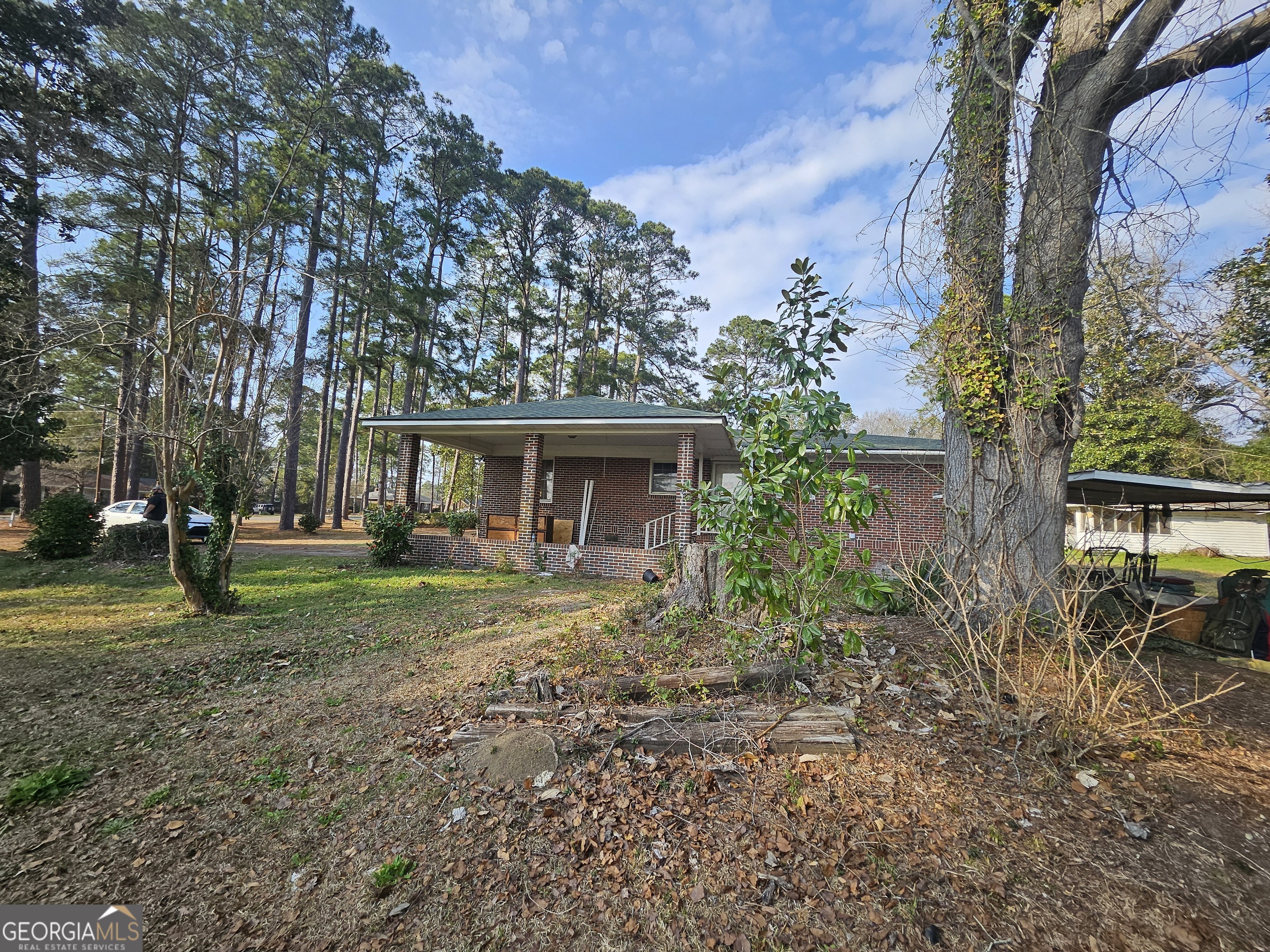 846 Harvey Street Millen, GA 30442 - Photo 26 of 34 a front view of a house with garden