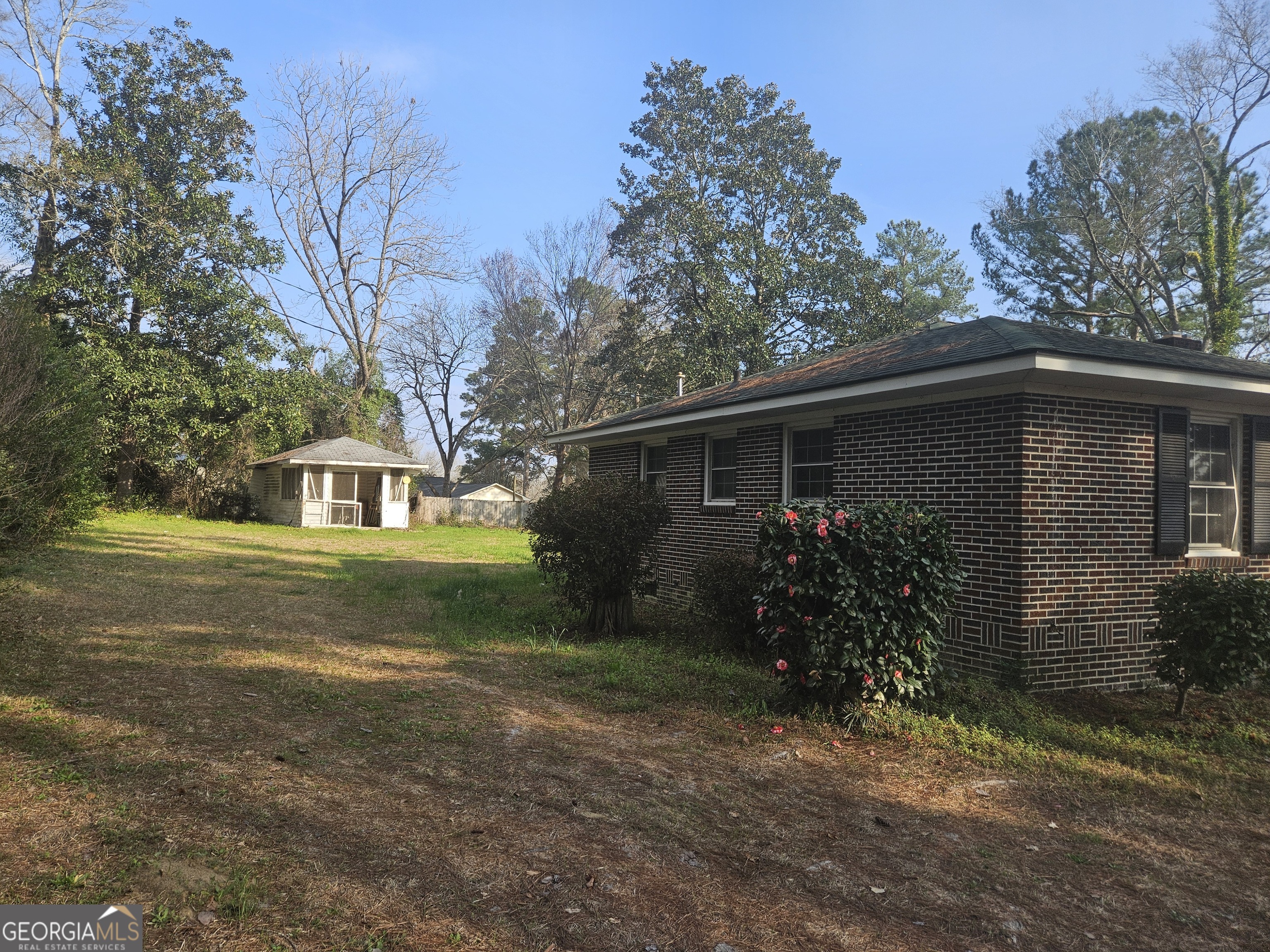 846 Harvey Street Millen, GA 30442 - Photo 31 of 34 a front view of house with yard and trees around