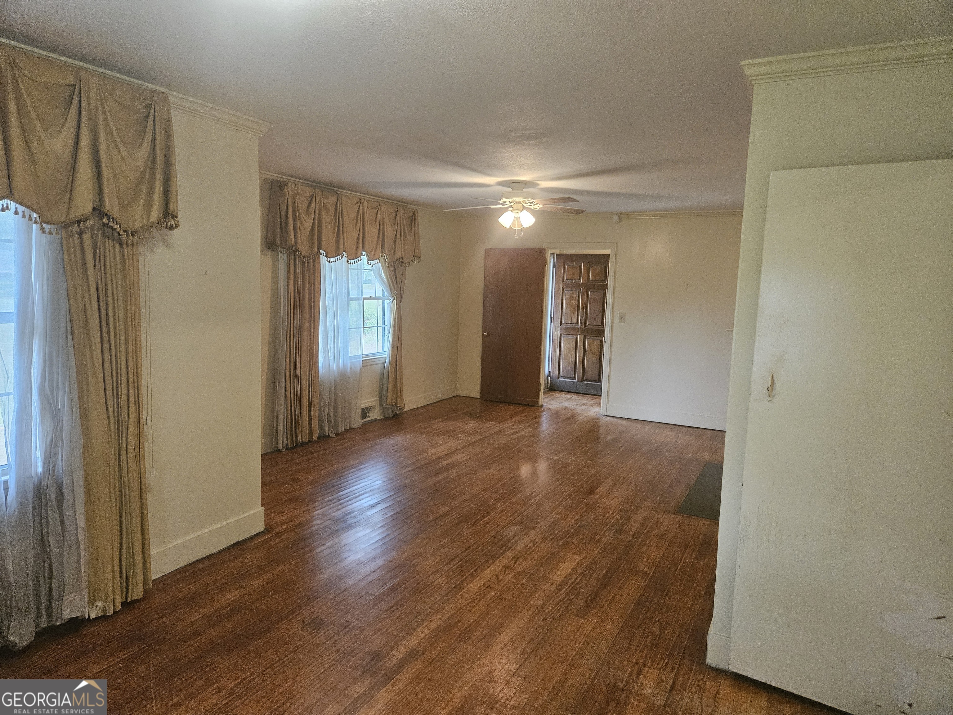 846 Harvey Street Millen, GA 30442 - Photo 8 of 34 a view of a room with wooden floor and window