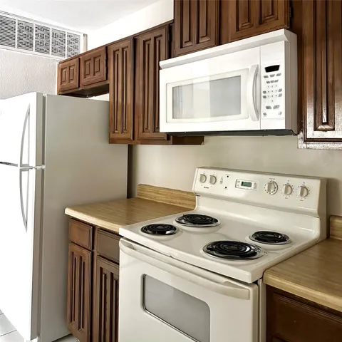 a kitchen with a stove and a microwave