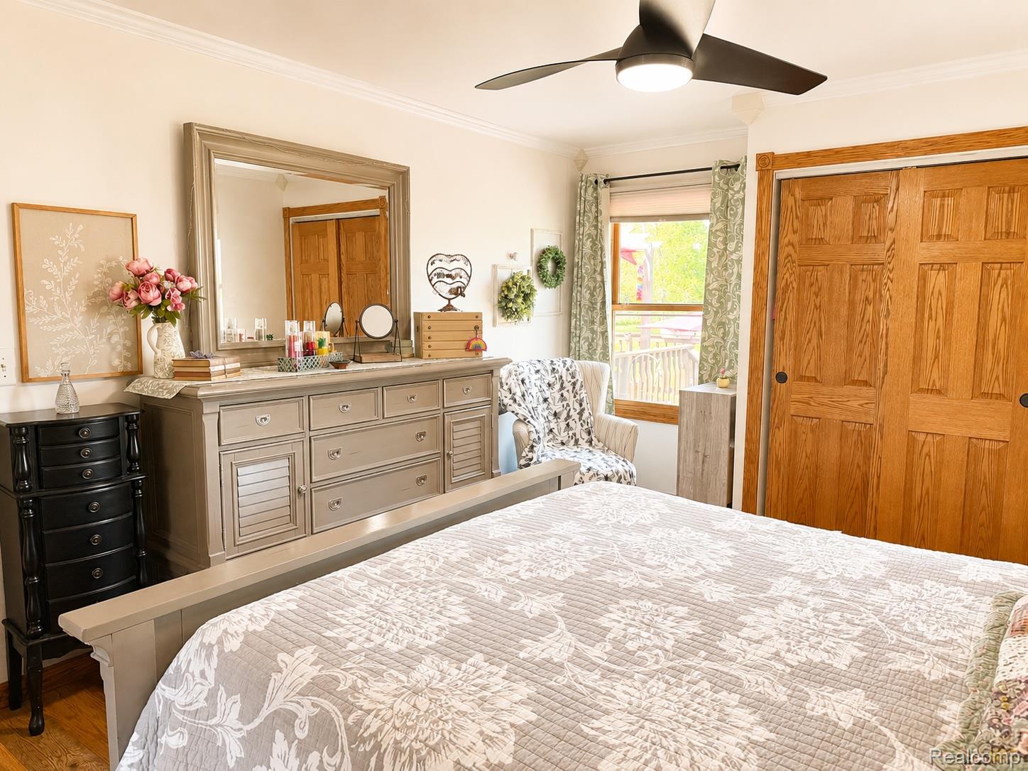 6860 Grand River Road Bancroft, MI 48414 - Photo 15 of 31 Bedroom featuring ornamental molding, a closet, a ceiling fan, and wood finished floors