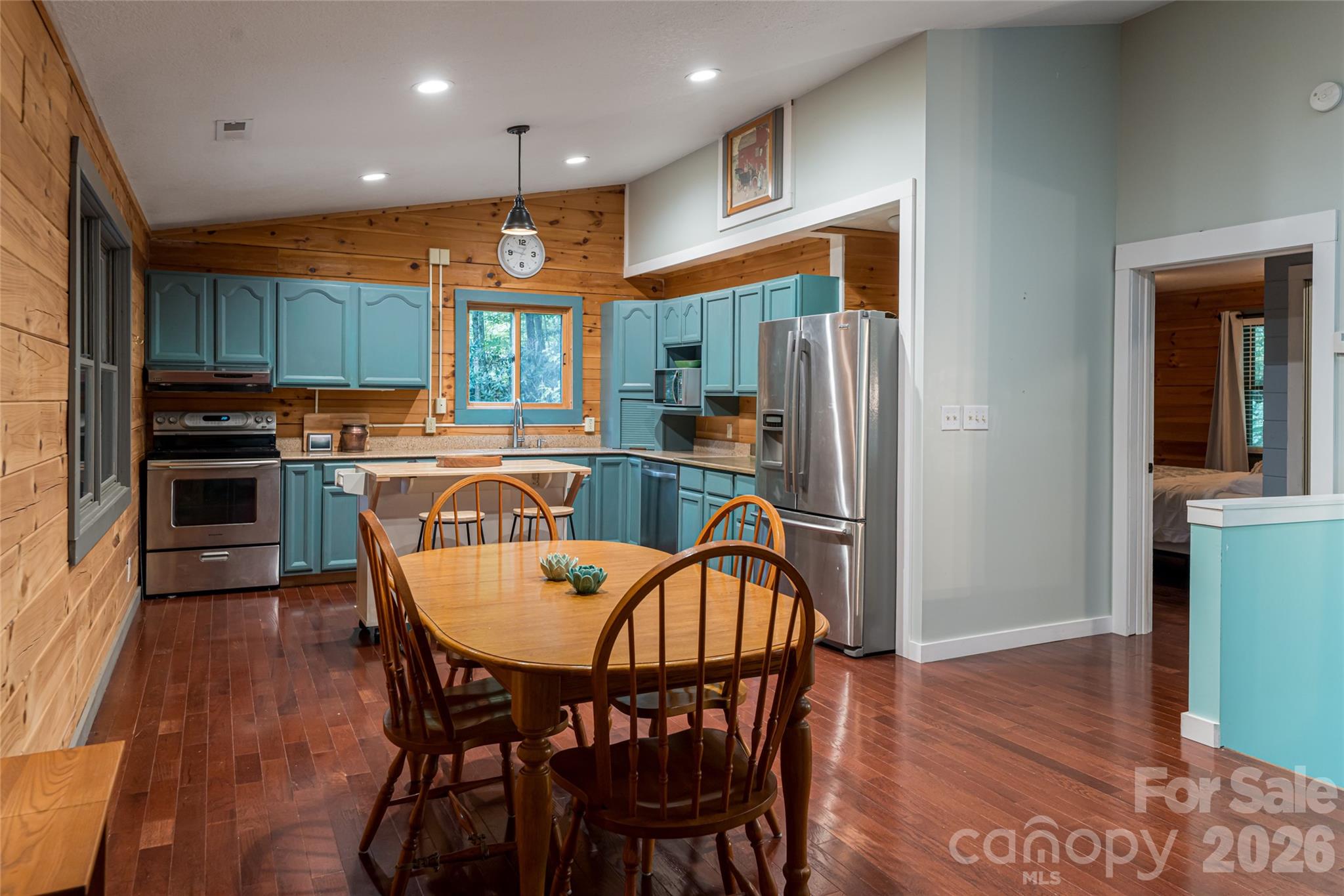 4035 Bald Creek Road Clyde, NC 28721 - Photo 11 of 43 a kitchen with stainless steel appliances granite countertop a dining table chairs refrigerator and sink