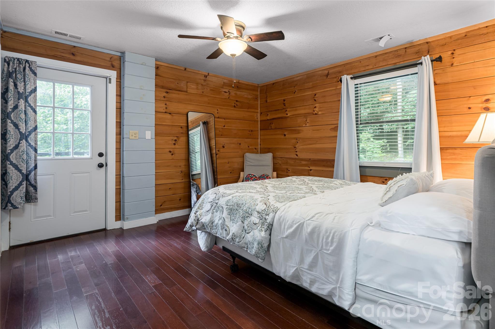 4035 Bald Creek Road Clyde, NC 28721 - Photo 15 of 43 a bedroom with a bed and a chandelier