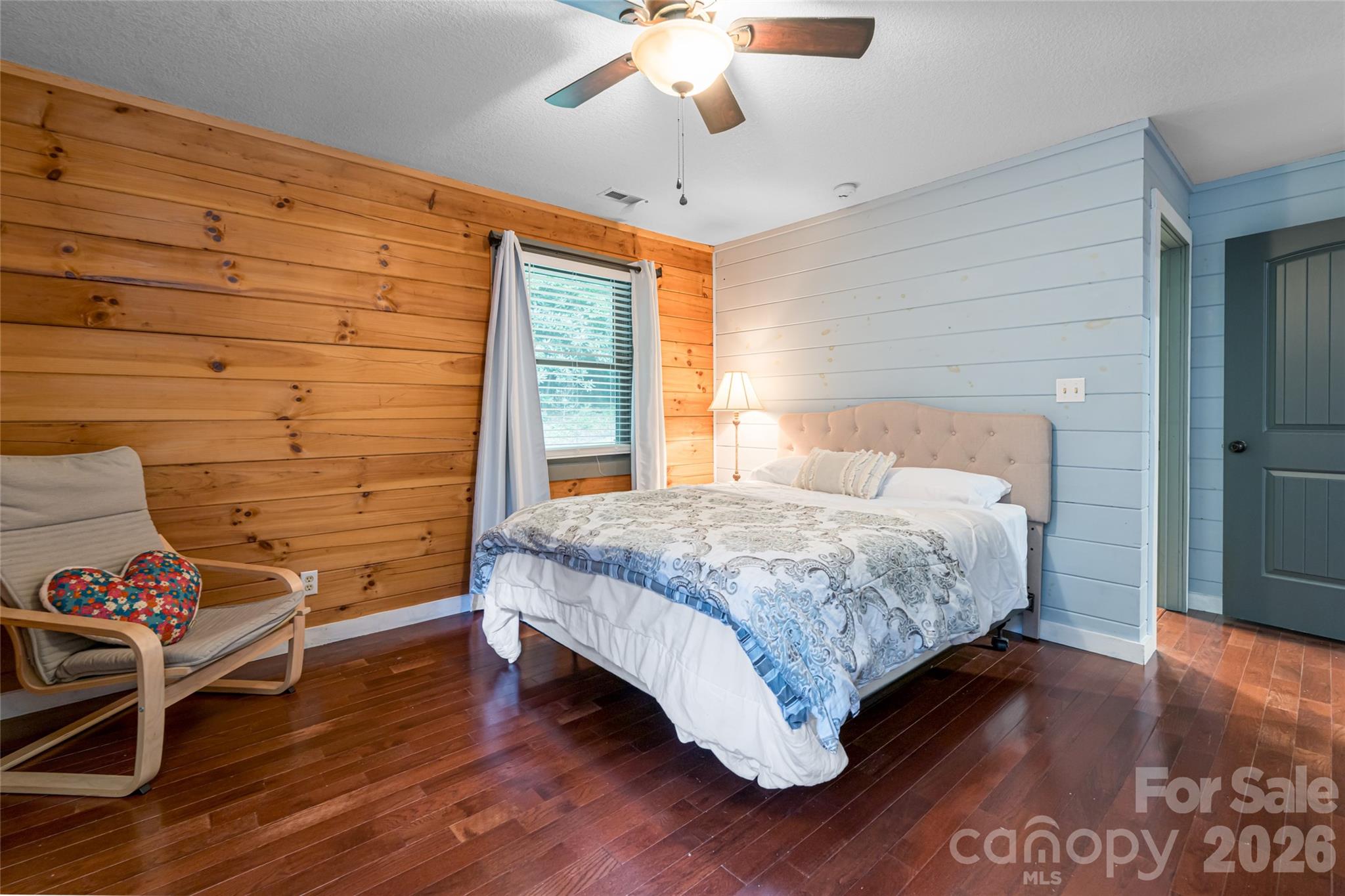4035 Bald Creek Road Clyde, NC 28721 - Photo 16 of 43 a bedroom with a bed and a chandelier