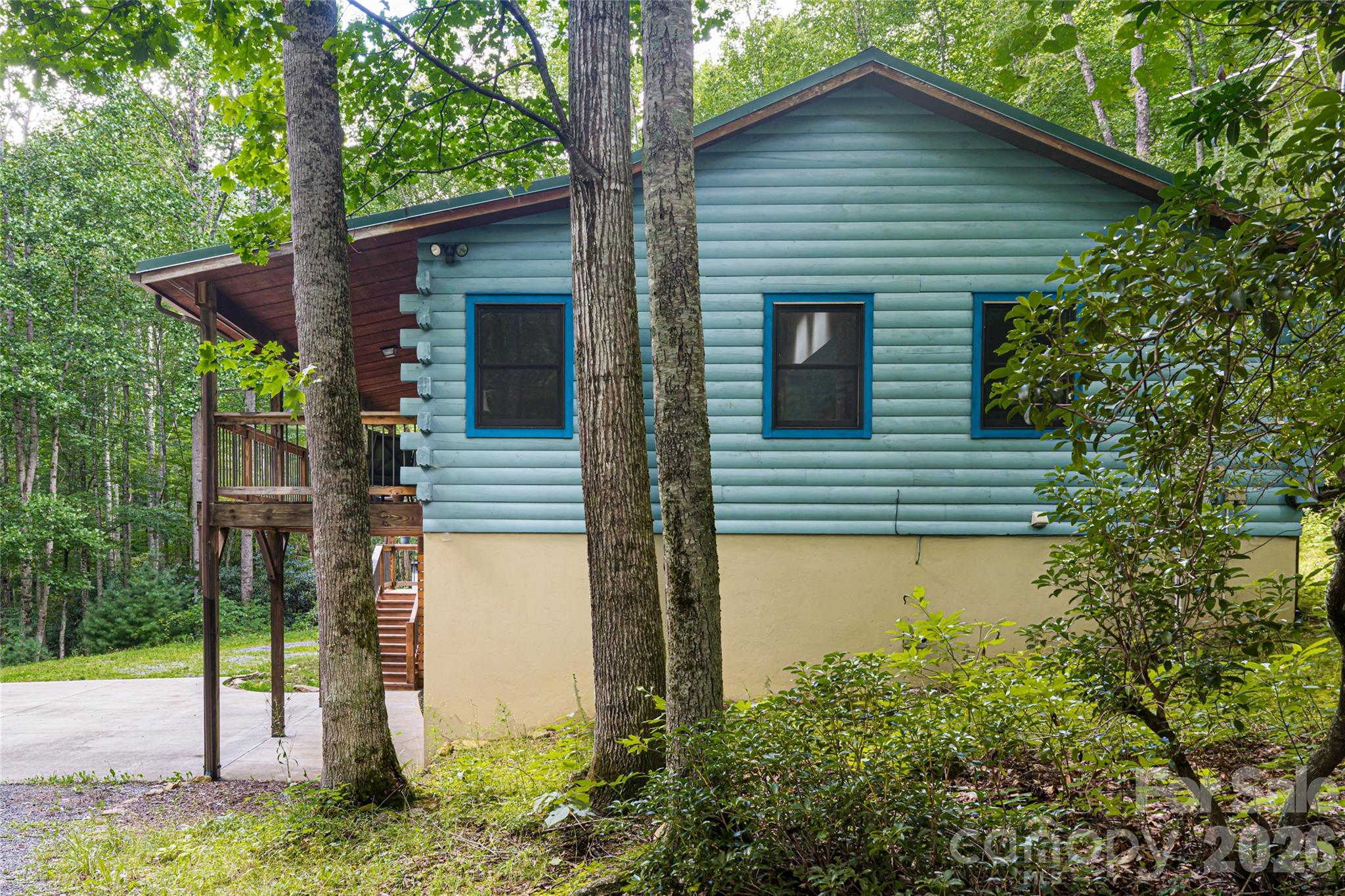 4035 Bald Creek Road Clyde, NC 28721 - Photo 35 of 43 a yellow house with trees in front of it