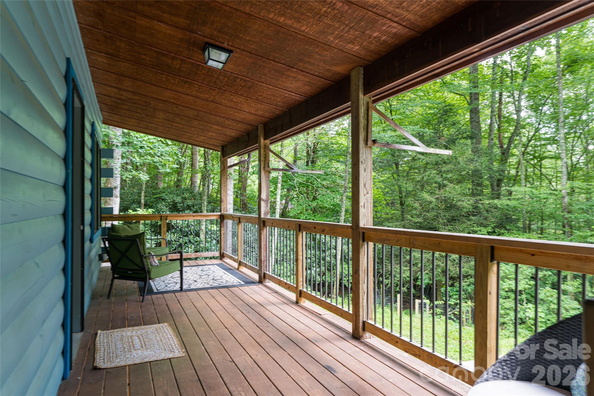 4035 Bald Creek Road Clyde, NC 28721 - Photo 5 of 43 a view of a balcony with chairs and wooden floor