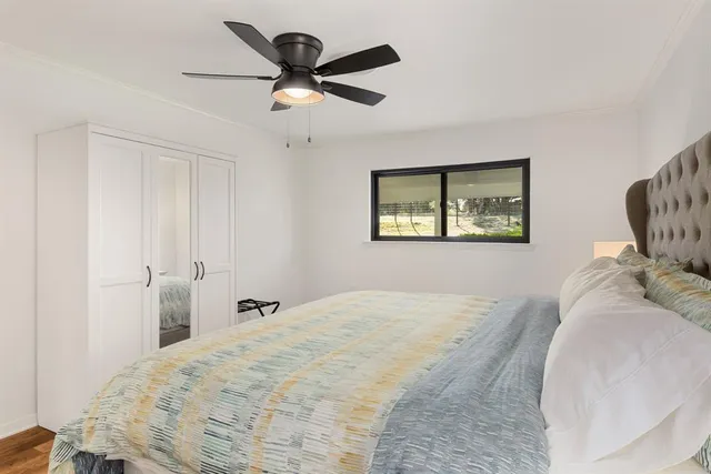 a bedroom with a large bed and a chandelier