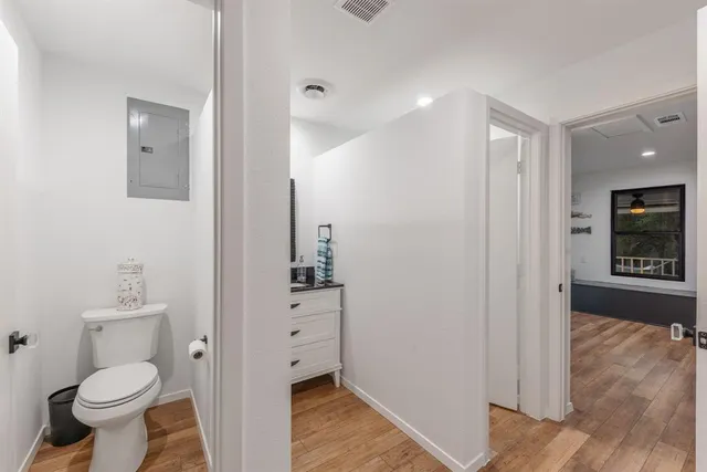 a bathroom with a toilet sink and a mirror