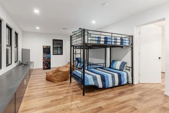 a bedroom with furniture and a large window