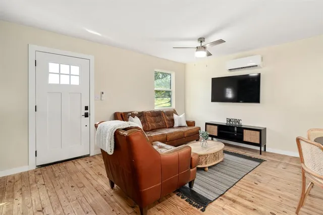 a living room with furniture and a flat screen tv