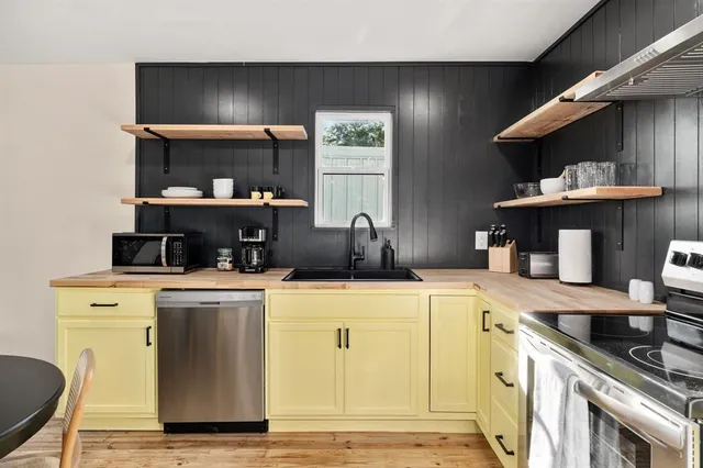 a kitchen with stainless steel appliances granite countertop a sink and cabinets
