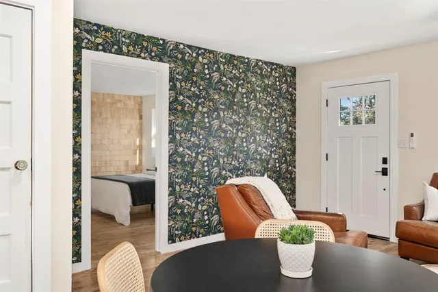 a dining room with furniture and wooden floor