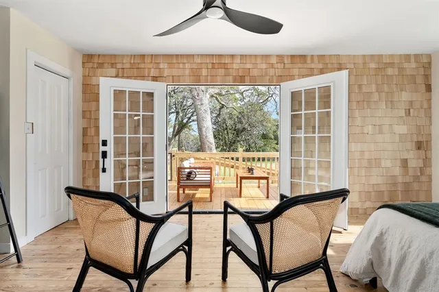 a view of a dining room with furniture and a window