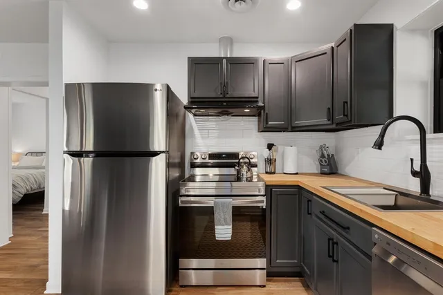 a kitchen with a sink stove and refrigerator