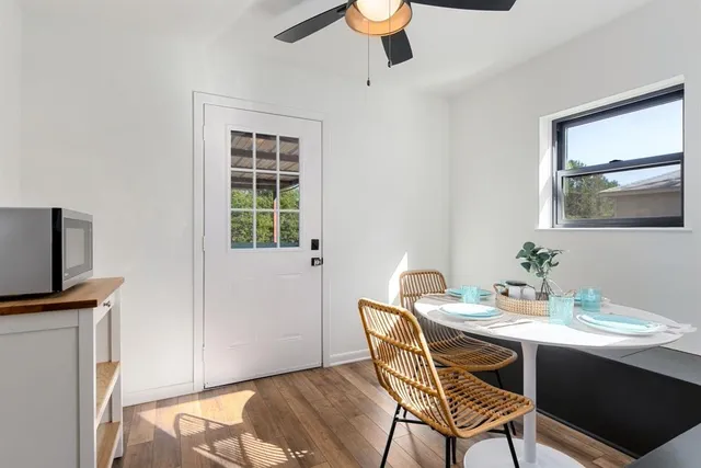 a view of a dining room with furniture window and wooden floor